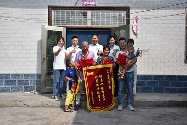 為老人頒發(fā)“德善之家育良才，視界職場(chǎng)成骨干”的錦旗